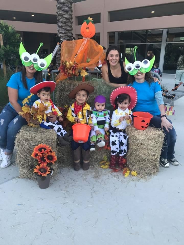 Family Dressed in Toy Story costumes posing 