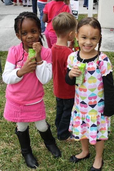 Little girls drinking juice boxes